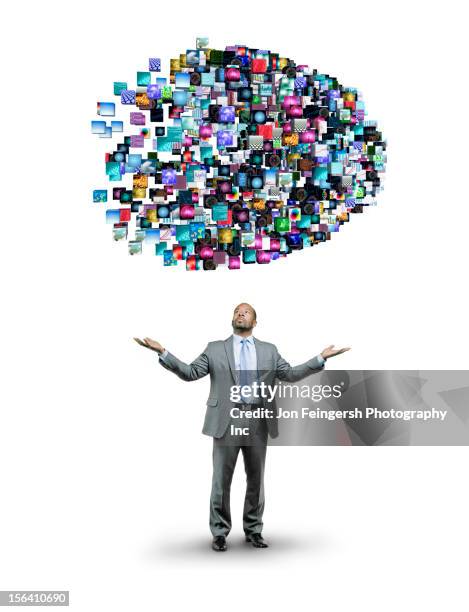 african american businessman underneath cloud of technology images - information overload stock-fotos und bilder