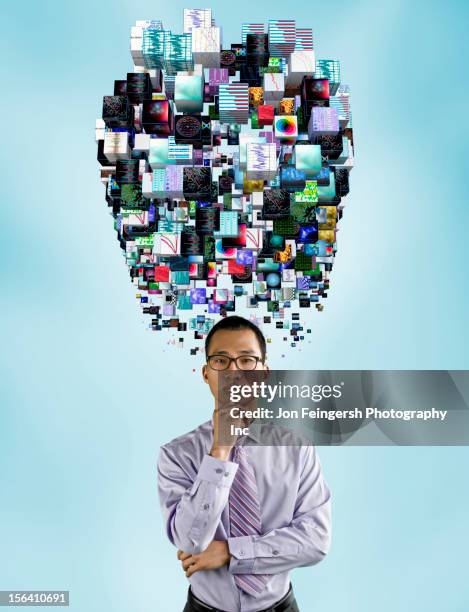 asian businessman underneath cloud of technology images - information overload stock-fotos und bilder