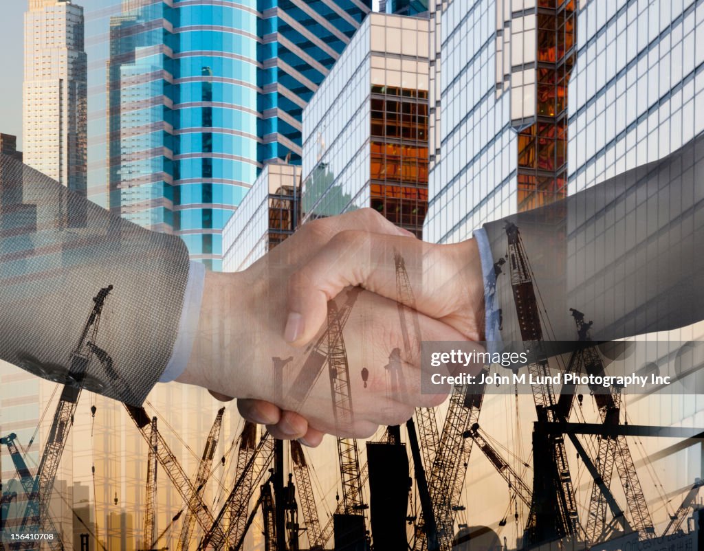 Montage of highrise buildings, cranes and businessmen shaking hands
