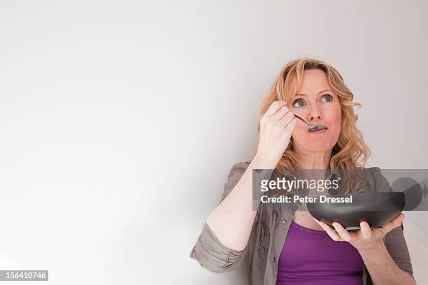 caucasian woman eating soup - eating soup stock pictures, royalty-free photos & images