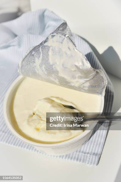 eating yogurt - yoghurt lid stock pictures, royalty-free photos & images