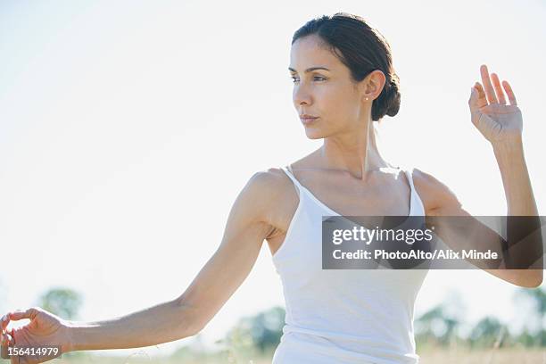 mid-adult woman practicing yoga - corpetto foto e immagini stock