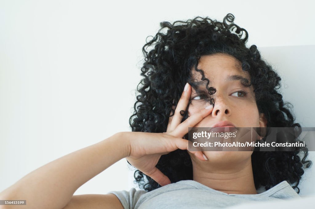 Young woman with bored expression on face