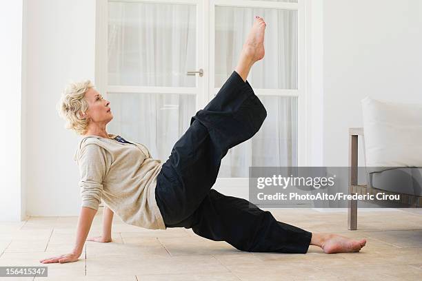 mature woman practicing pilates - older woman legs fotografías e imágenes de stock