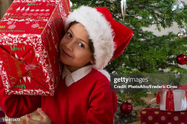 boy holding christmas present on his shoulder, portrait - carrying on shoulders stock pictures, royalty-free photos & images