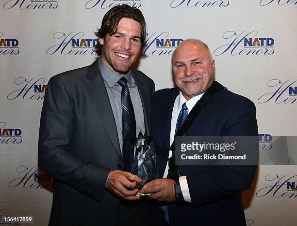 Nashville Predators Head Coach Barry Trotz presents NHL Nashville Predators player Mike Fisher with his NATD Award during the 2012 NATD Honors at The...