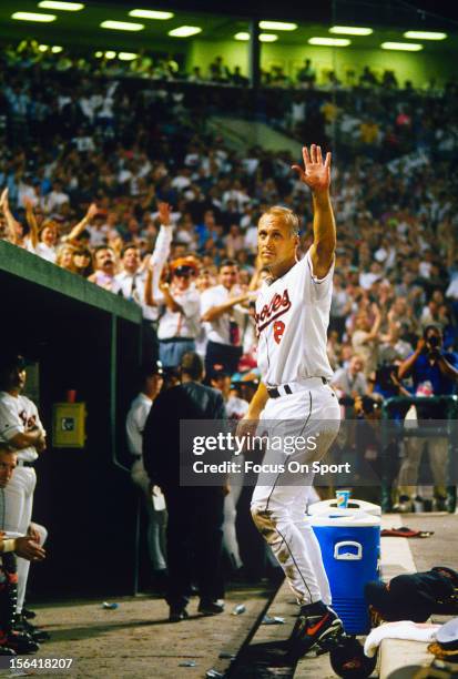 Cal Ripken Jr of the Baltimore Orioles acknowledge the fans as he gets a standing ovation for playing in his 2131st consecutive Major League baseball...