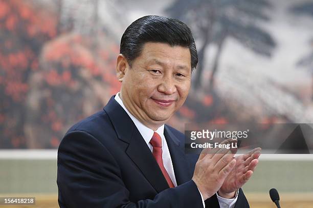 Chinese Vice President Xi Jinping, one of the members of new seven-seat Politburo Standing Committee, greets the media at the Great Hall of the...