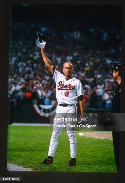 Cal Ripken Jr of the Baltimore Orioles acknowledge the fans as he gets a standing ovation for playing in his 2131st consecutive Major League baseball...