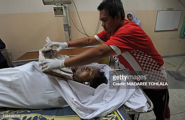 Thai hospital worker inspects the body of a Muslim villager at a hospital after he was shot dead by suspected separatist militants in the Cha-nea...