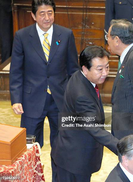 Japanese Prime Minister and ruling Democratic Party of Japan leader Yoshihiko Noda and opposition Liberal Democratic Party leader Shinzo Abe are seen...