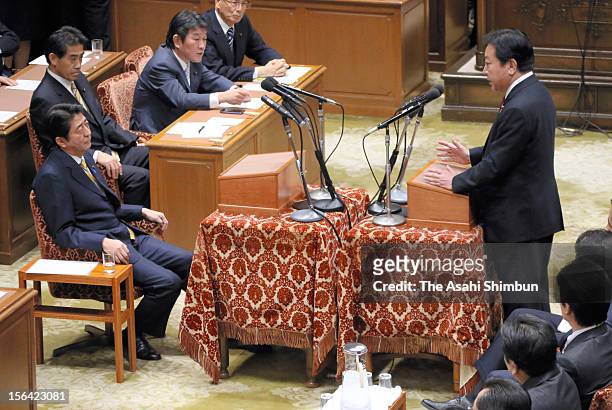 Japanese Prime Minister and ruling Democratic Party of Japan leader Yoshihiko Noda speaks while opposition Liberal Democratic Party leader Shinzo Abe...