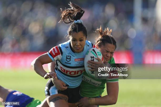 Tiana Penitani of the Cronulla Sharks is tackled during the round one NRLW match between Cronulla Sharks and Canberra Raiders at PointsBet Stadium,...