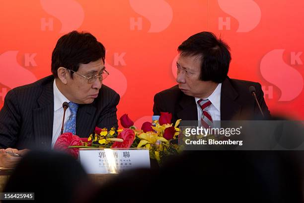 Raymond Kwok, co-chairman of Sun Hung Kai Properties Ltd., left, and Thomas Kwok, co-chairman, converse at the end of a news conference in Hong Kong,...