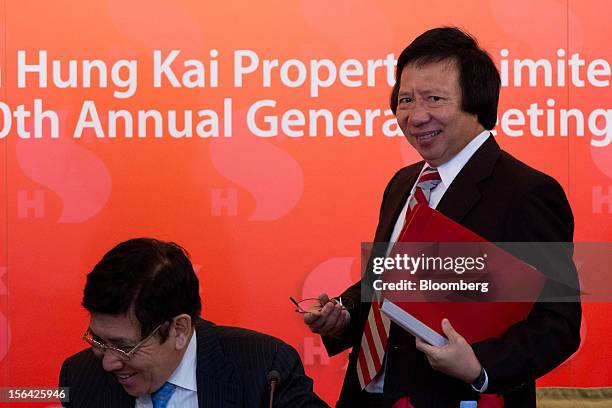 Raymond Kwok, co-chairman of Sun Hung Kai Properties Ltd., left, and Thomas Kwok, co-chairman, laugh at the end of a news conference in Hong Kong,...