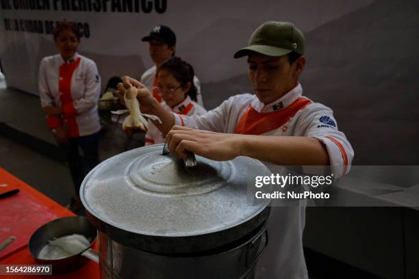 Students from the Instituto de Estudios Superiores de Turismo, get ready to prepare chilacayote mixiote , on the occasion of the Pre-Hispanic...