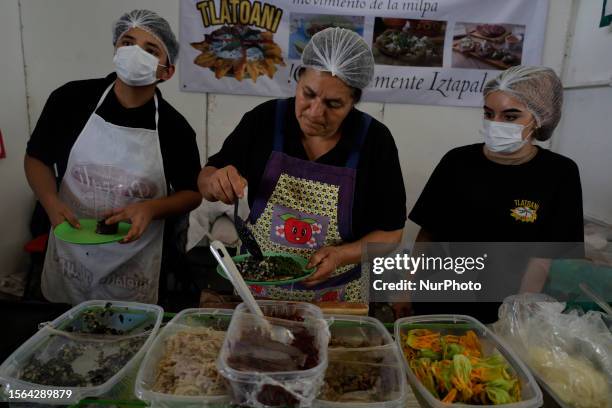 Two people prepare a tlatoani , during the Pre-Hispanic Gastronomic Fair in the Iztapalapa mayor's office, Mexico City, where the roots of Mexican...