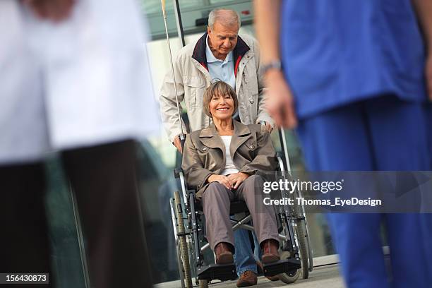 senior couple leaving the hospital - goodbye single word stock pictures, royalty-free photos & images