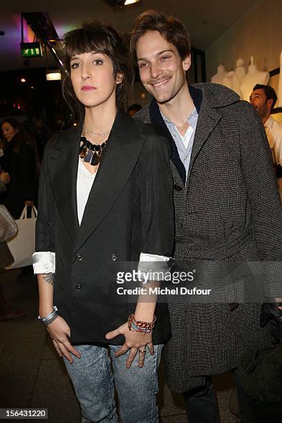 Daphné Bürki and Andy Gilet attend the Maison Martin Margiela With H&M Collection Launch at H&M Champs Elysees on November 14, 2012 in Paris, France.