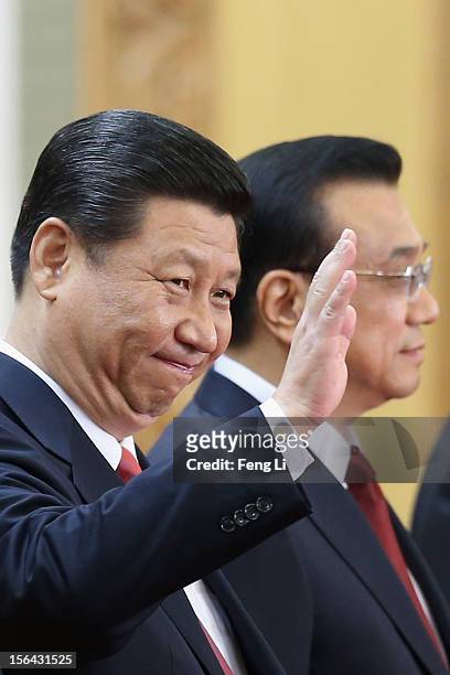 Members of the new Politburo Standing Committee Xi Jinping and Li Keqiang greet the media at the Great Hall of the People on November 15, 2012 in...