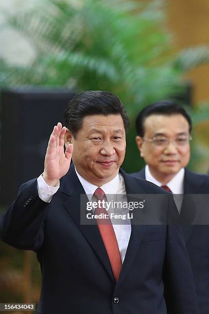 Members of the new Politburo Standing Committee Xi Jinping and Li Keqiang greet the media at the Great Hall of the People on November 15, 2012 in...