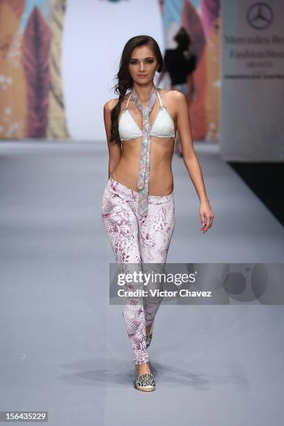 Model walks the runway at the spring/summer 2013 collection of Agua Bendita during the third day of Mereceds-Benz Fashion Week Mexico at Carpa Santa...