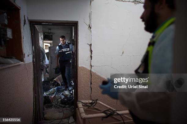 Israeli police inspect an apartment which was hit by a rocket fired by Palestinian militants, killing three people on November 15, 2012 in Kiryat...