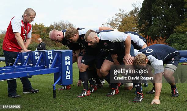 The England front row Joe Marler, Tom Youngs and Dan Cole practice scrummaging during the England training session held at Pennyhill Park on November...