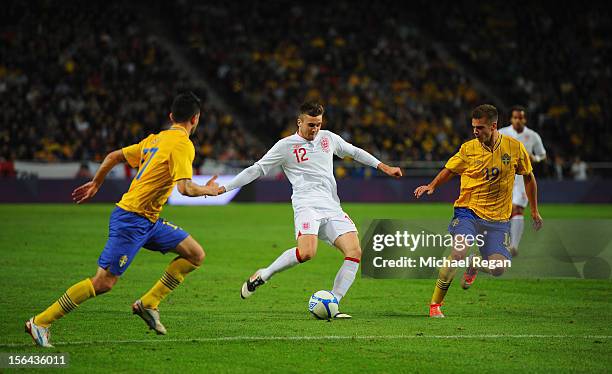 Carl Jenkinson of England in action with Behrang Safari and Alex Kacaniklic of Sweden during the international friendly match between Sweden and...