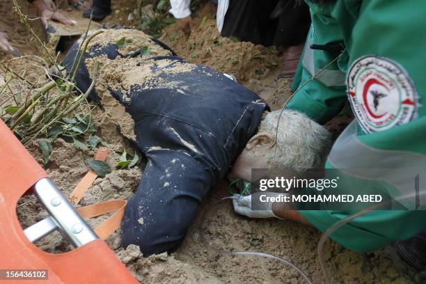 Palestinian paramedics try to resuscitate a man injured in an Israeli air raid on the area of Twaam in the northern Gaza town of Beit Lahia on...