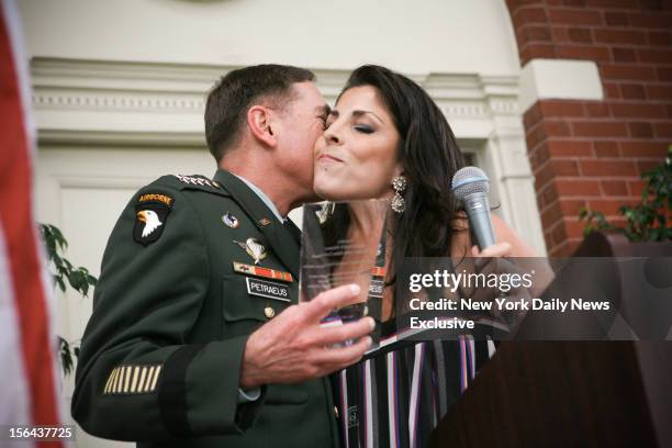 General David Petraeus kisses Jill Kelley after accepting community service award presented at Kelley's home during the summer of 2011.