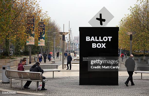 People pass a mock ballot box erected to encourage people to vote in the Bristol mayoral election on November 15, 2012 in Bristol, England. Although...