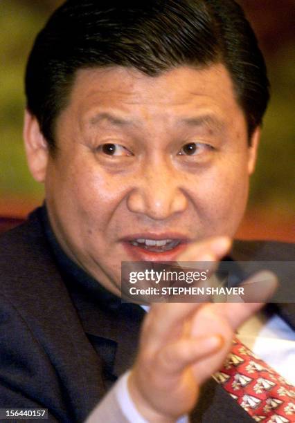 Governor of China's coastal Fujian province Xi Jinping responds to a journalist's question 23 February 2000 during an interview at the central...