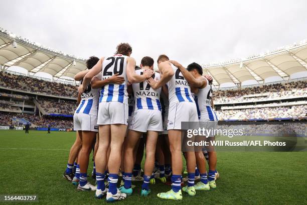 IPERTH, AUSTRALIA The Kangaroos form a huddle during the 2023 AFL Round 20 match between the West Coast Eagles and the North Melbourne Kangaroos at...