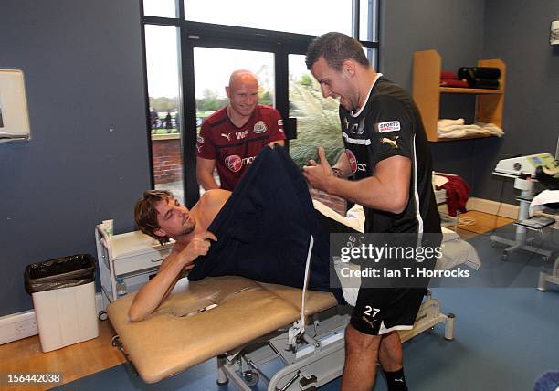 Steven Taylor holds a skin from a tarantula spider and scares goalkeeper Tim Krul during an Australia themed day at the Newcastle United training...