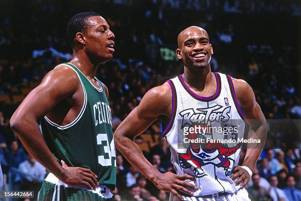 Vince Carter of the Toronto Raptors laughs with Paul Pierce of the Boston Celtics during a game circa 1999 at the Air Canada Centre in Toronto,...