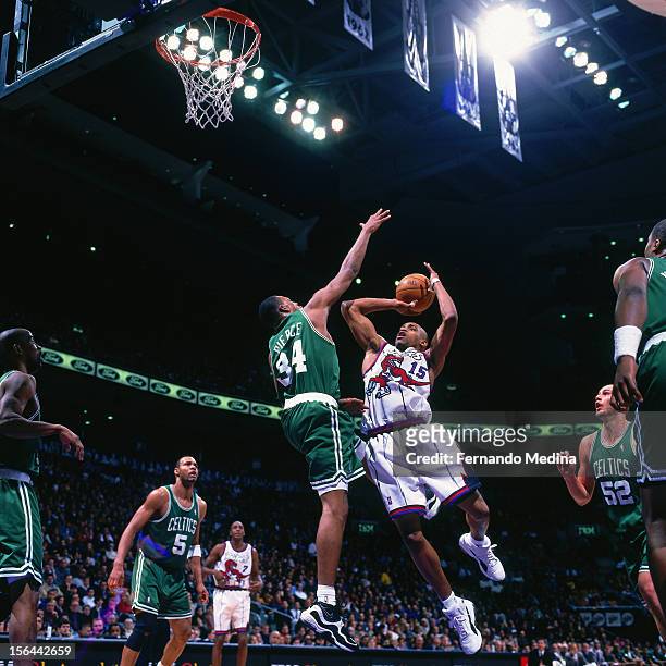 Vince Carter of the Toronto Raptors shoots the ball against Paul Pierce of the Boston Celtics during a game circa 1999 at the Air Canada Centre in...