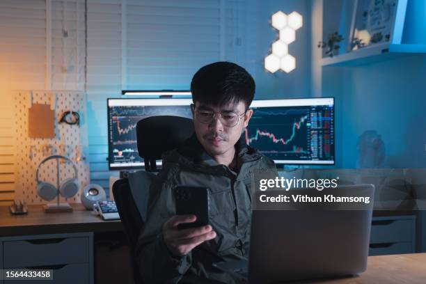 young asian trader concentrated on stock patterns at home - block chain stock pictures, royalty-free photos & images