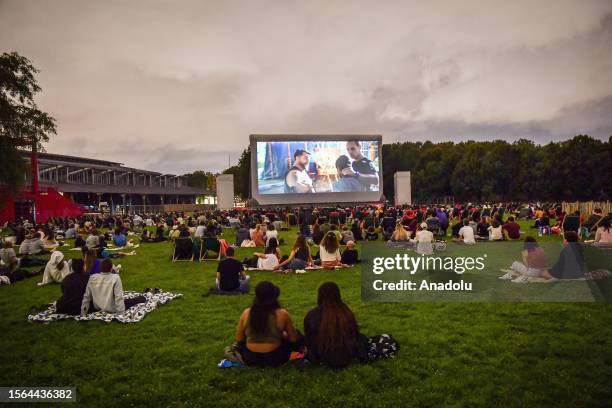 Attendees watch a movie projected on the open-air cinema at Parc de la Villette in Paris, France on July 29, 2023.