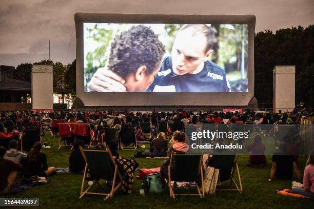 Attendees watch a movie projected on the open-air cinema at Parc de la Villette in Paris, France on July 29, 2023.