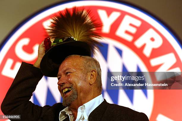 Man wearing a hat with the traditional decoration 'Gamsbart' smiles during the FC Bayern Muenchen general meeting at Audi Dome on November 15, 2012...
