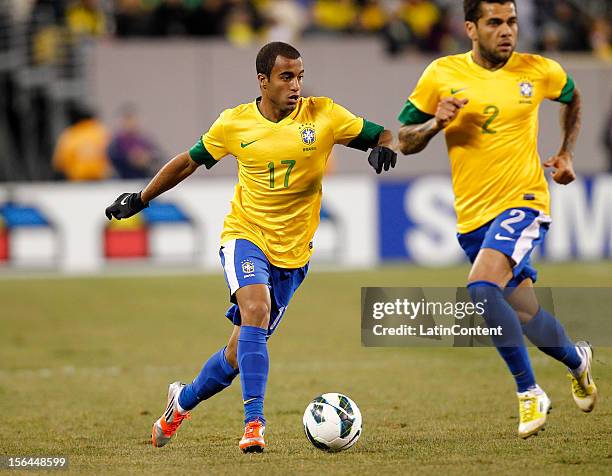 Lucas of Brazil moves the ball by Daniel Alves of Brazil during a FIFA Friendly match between Colombia and Brazil at the MetLife Stadium on November...