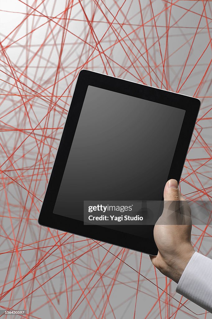 Digital tablet and a red thread