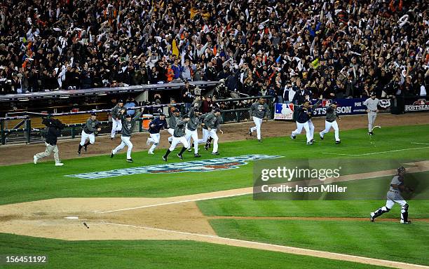 Justin Verlander of the Detroit Tigers and his teammates run out of the dugout to celebrate on the field after the Tigers won 8-1 against the New...