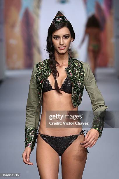 Model walks the runway at the spring/summer 2013 collection of Agua Bendita during the third day of Mereceds-Benz Fashion Week Mexico at Carpa Santa...