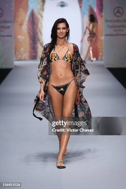 Model walks the runway at the spring/summer 2013 collection of Agua Bendita during the third day of Mereceds-Benz Fashion Week Mexico at Carpa Santa...