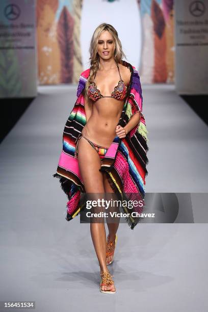 Model walks the runway at the spring/summer 2013 collection of Agua Bendita during the third day of Mereceds-Benz Fashion Week Mexico at Carpa Santa...