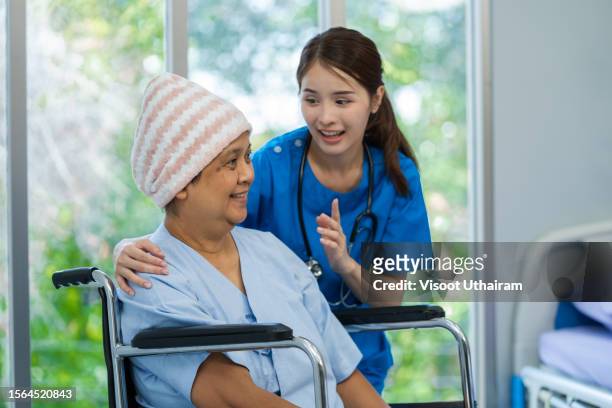 asian female doctor giving hope and encourage to woman patient have stressed with cancer at hospital. - receiving treatment concerned stock-fotos und bilder