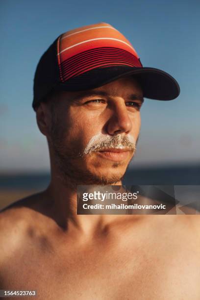mustache from sunscreen - hunky guy on beach stock pictures, royalty-free photos & images
