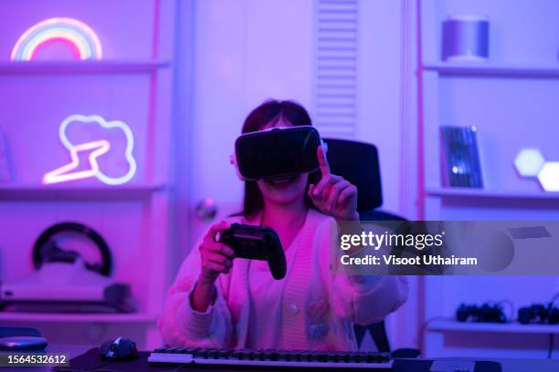 asian gamer playing game with wearing vr glasses. - gaming station stock pictures, royalty-free photos & images